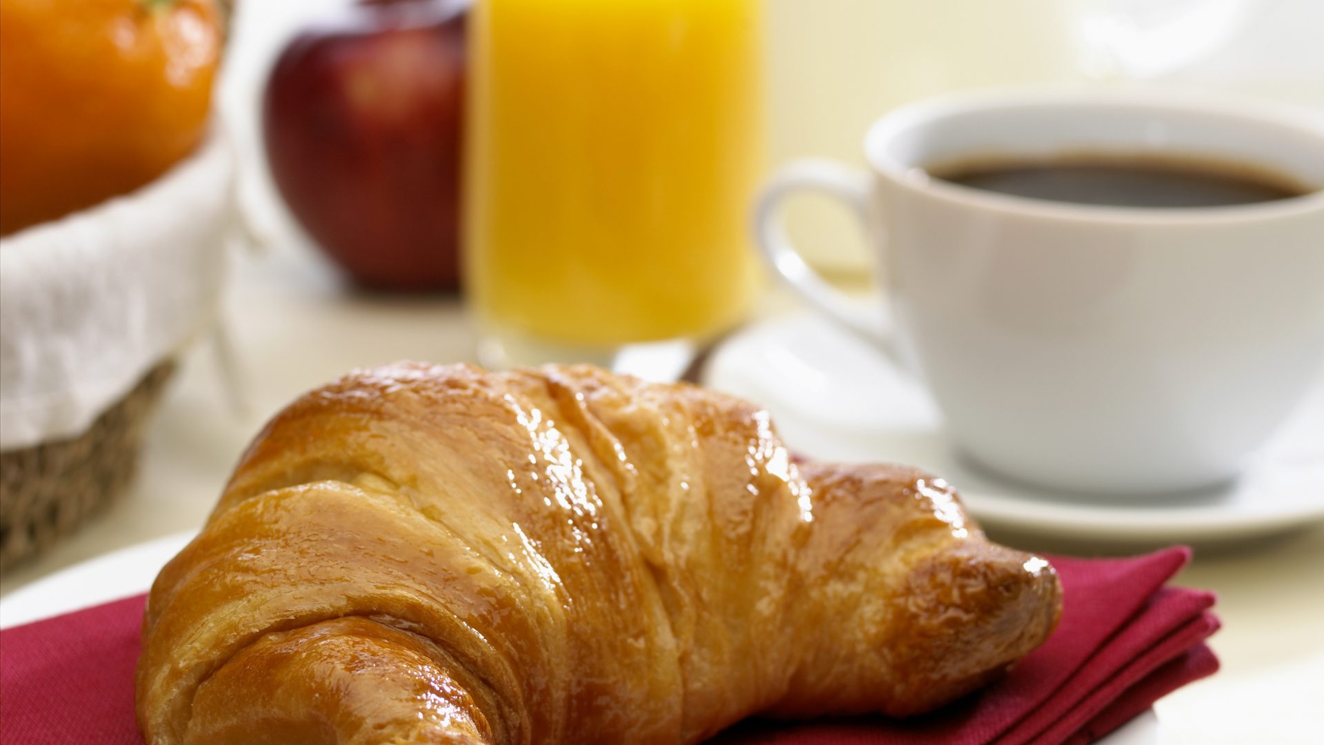 Croissant, coffee, orange juice, and fruit breakfast